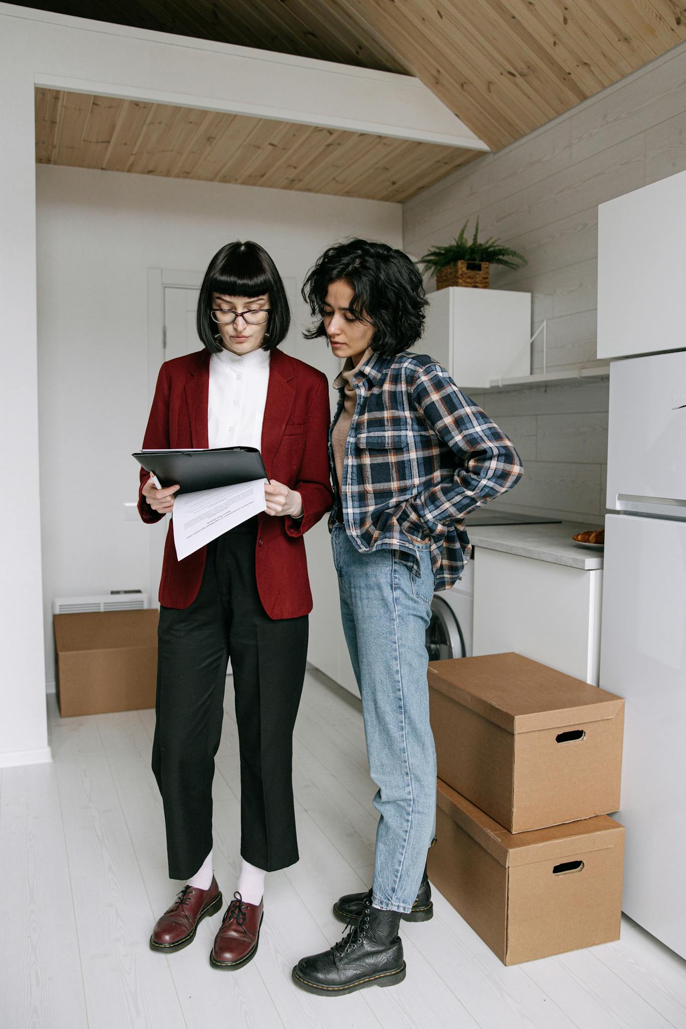 Real estate agent and client discussing documents in a modern apartment.